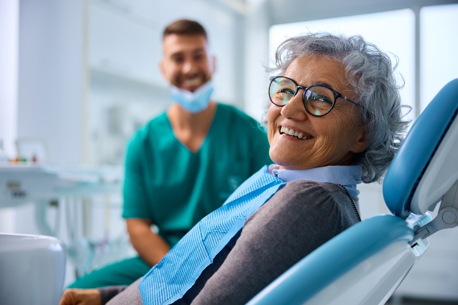Dentist providing care to elderly patient